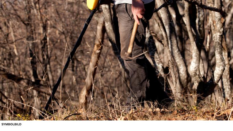 Mit Metalldetektor im Wald mit kleiner Suchspule